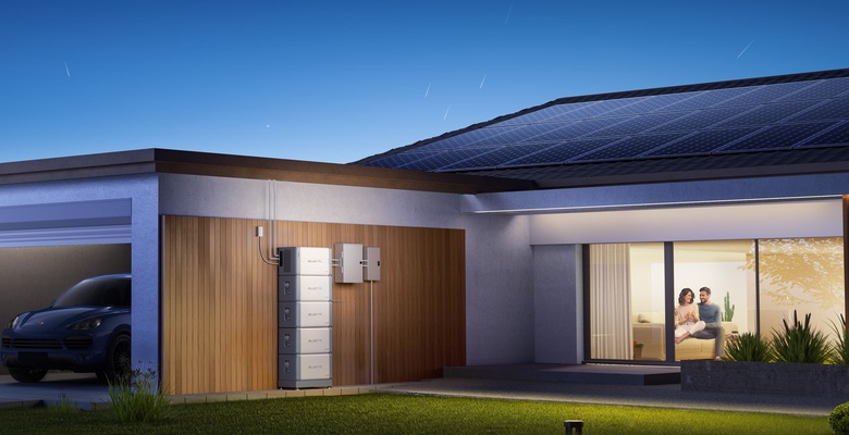Modern home with rooftop solar panels and BLUETTI wall battery backup