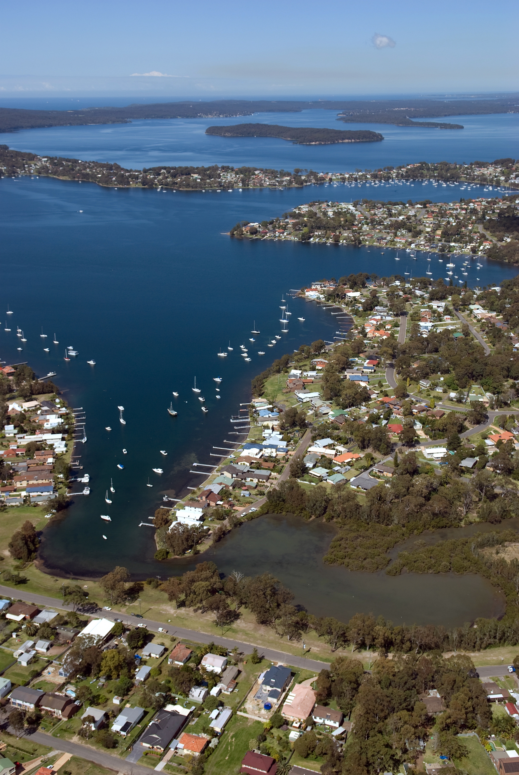 Aerial view of Lake Macquarie with suburban housing along the shoreline